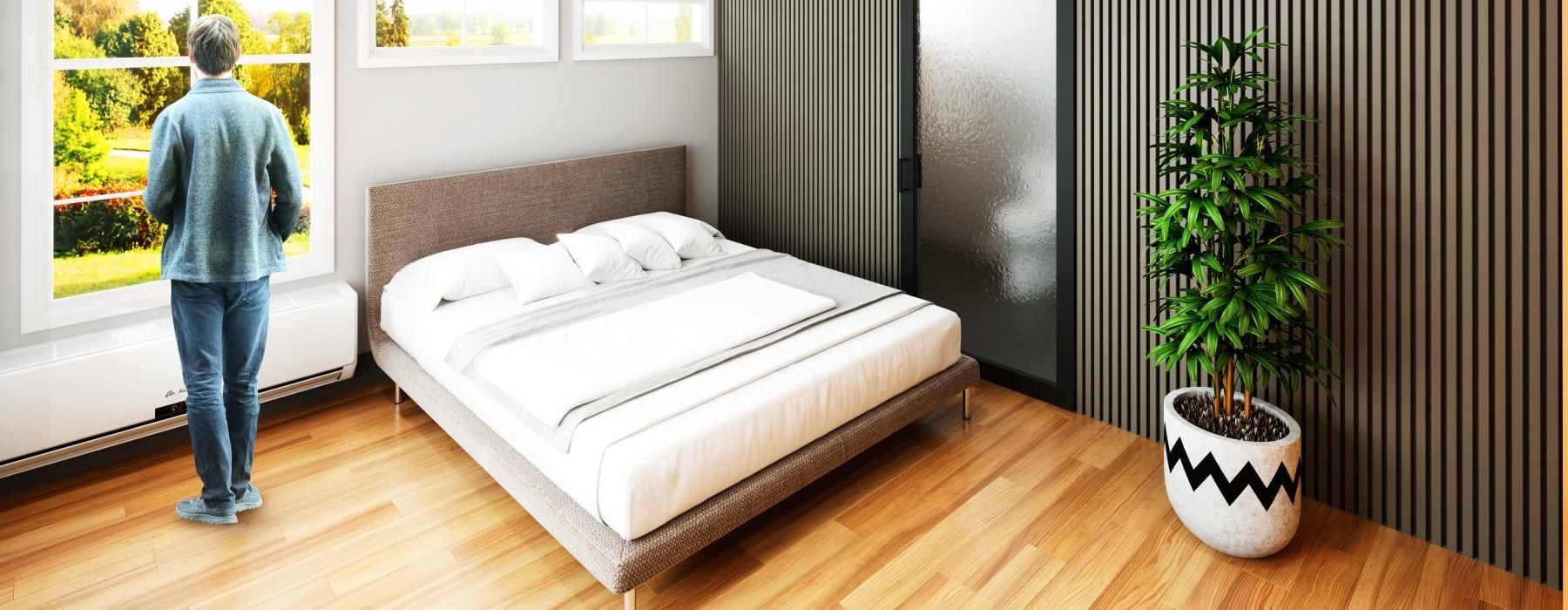 a person standing in a room with a bed and a ceiling fan