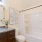 bathroom with tub and mirrors
